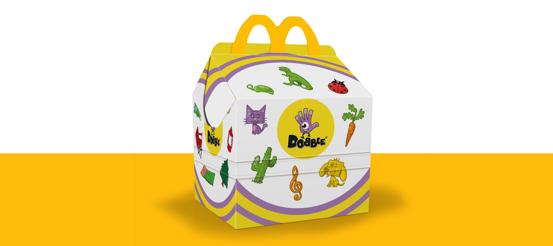 Happy Meal box with colourful animals, a sandcastle, a cactus, a treasure chest, a sun, a carrot and a treble clef.