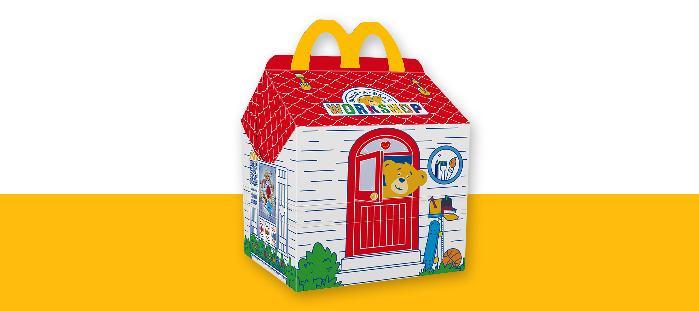 Happy Meal box with colourful animals, a sandcastle, a cactus, a treasure chest, a sun, a carrot and a treble clef.
