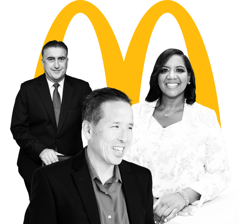  Three McDonald’s Franchisees in front of the McDonald’s golden arches.